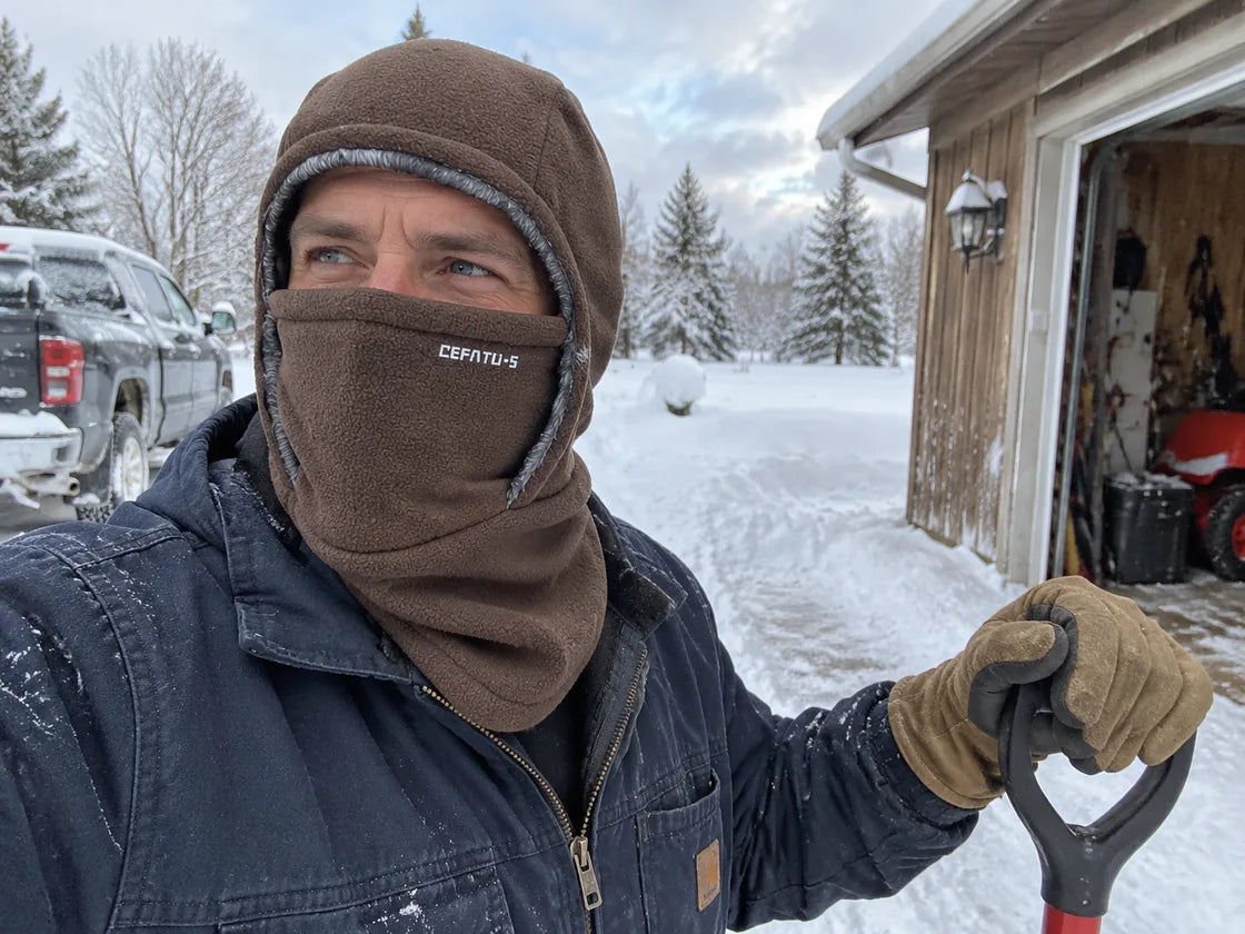 Brown winter hood while shoveling snow
