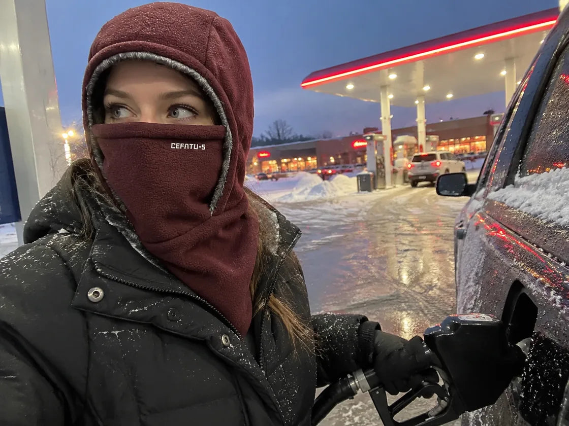 Burgundy winter hood at a snowy gas station