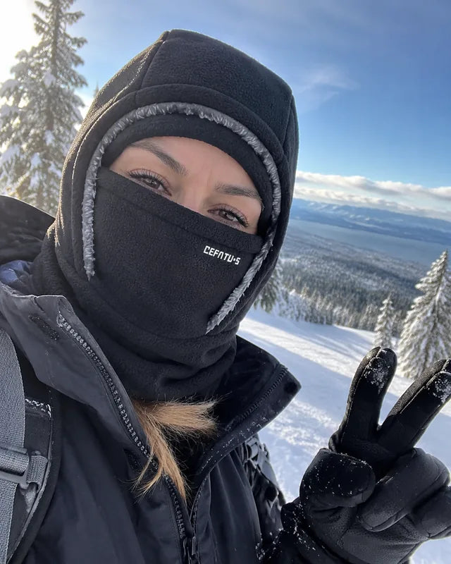 Black winter hood selfie with snowy mountains