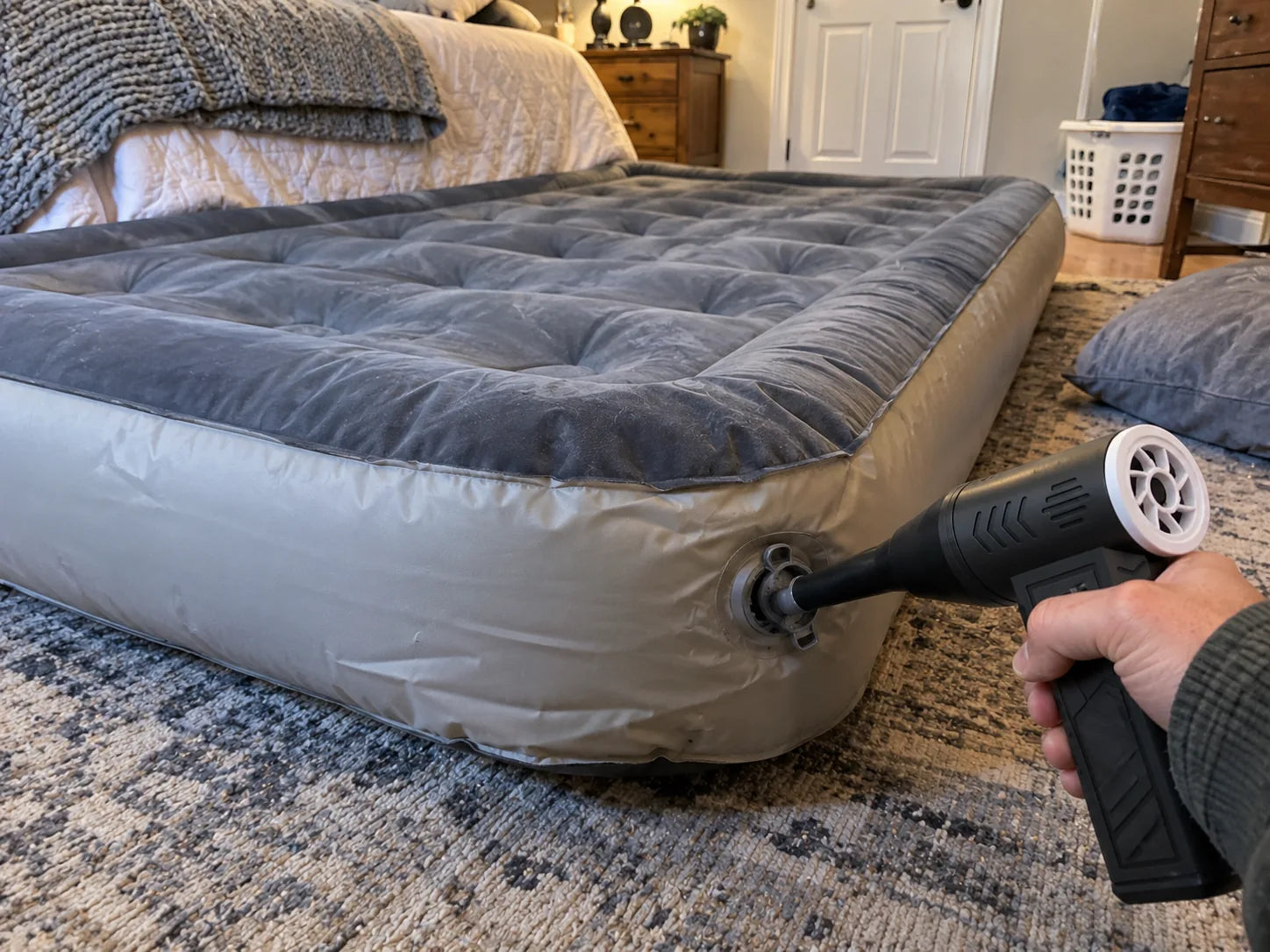 Cordless air duster inflating an air mattress
