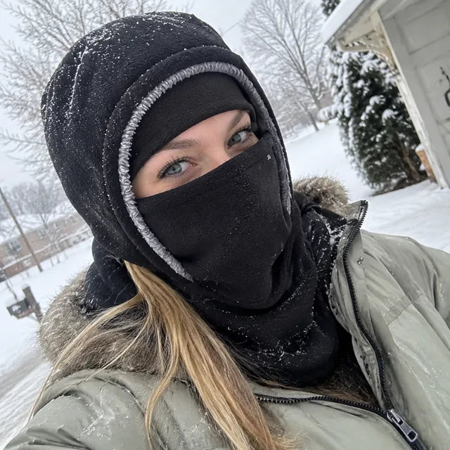 Black winter hood selfie outside a snowy home
