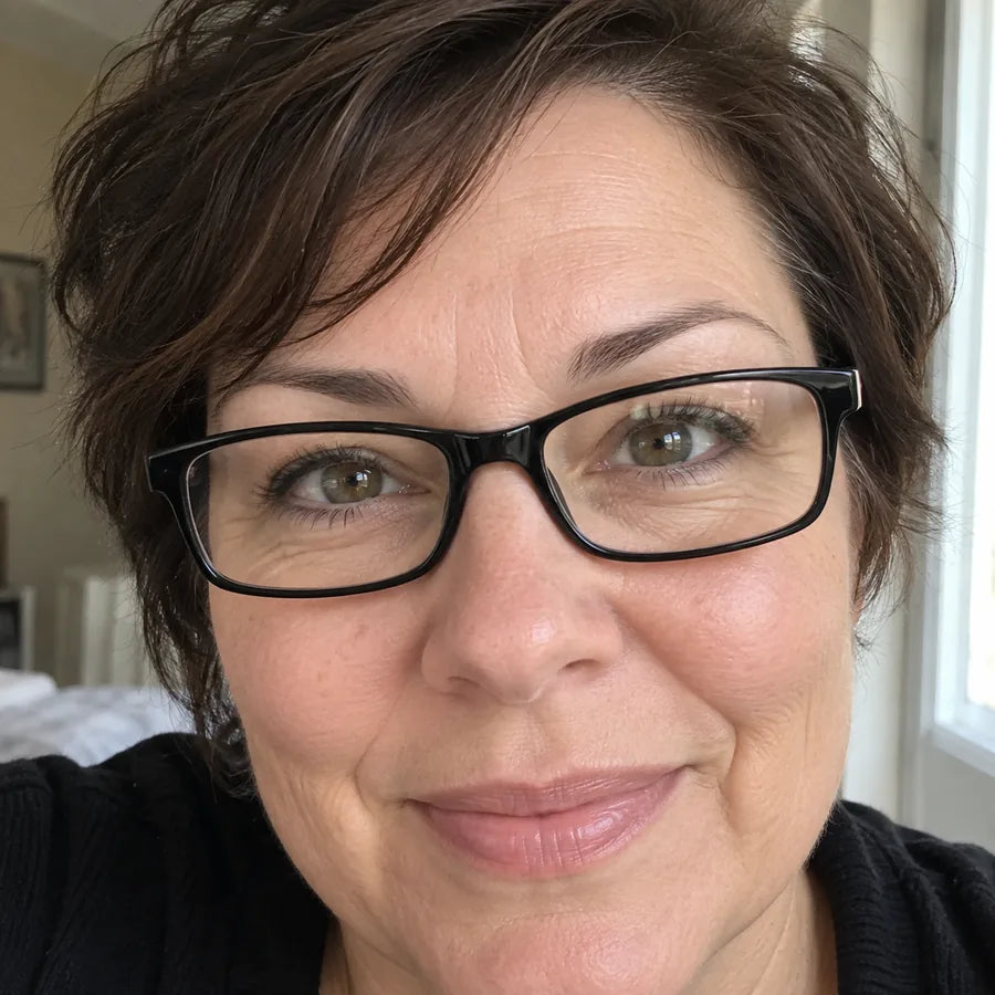 Woman wearing black glasses close up at home