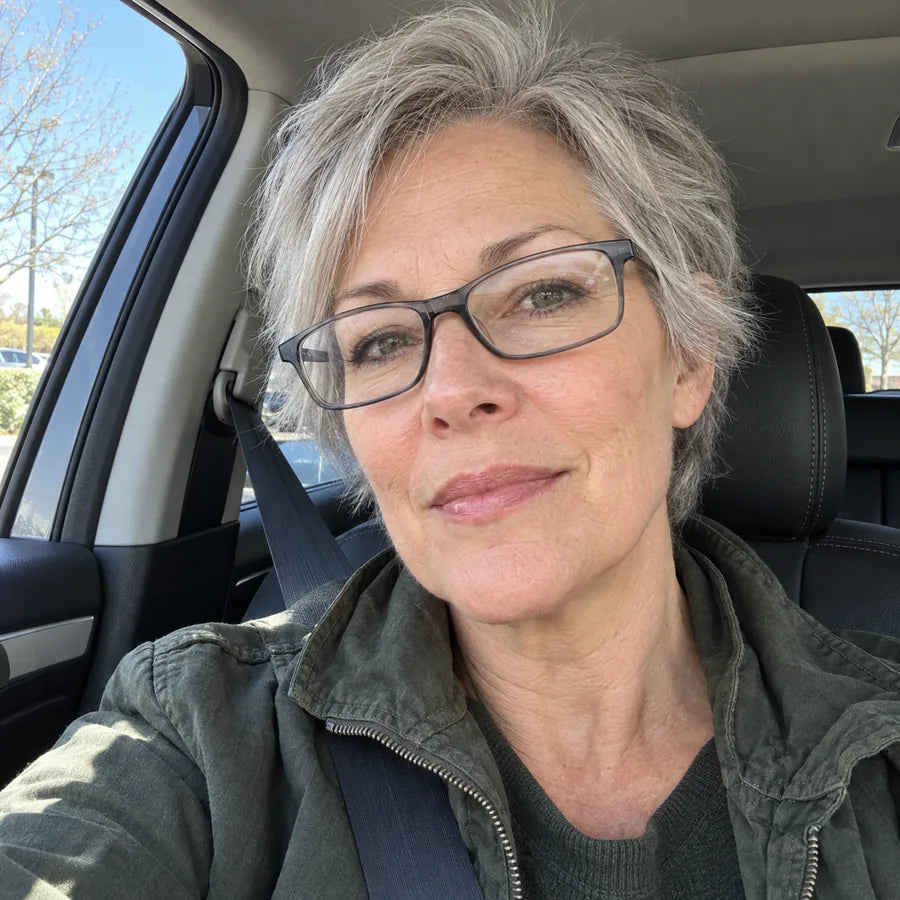 Woman wearing gray glasses while sitting in a car